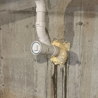 a white pipe in a concrete wall